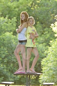 Girls standing on picnic table