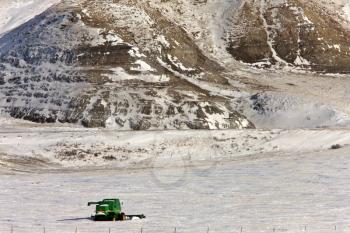Combine and hills in Winter Saskatchewan