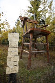 Comical signs by giant chair at Ghost Lake Alberta