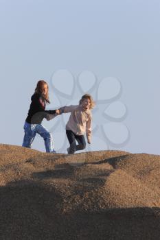 Young Girls Playing in Gravel