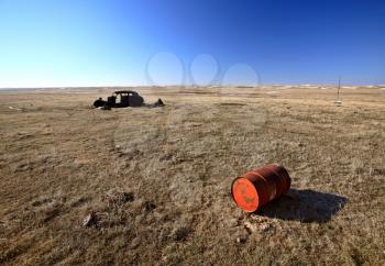 Old Barrell and Abandoned Car in Field
