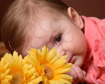 Young baby posing with flower