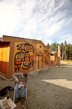 Native carving wood outside native lodge