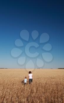 Mother and son in Saskatchewan wheat crop