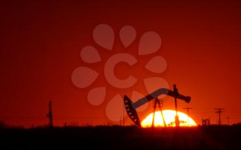 Oil pump in Saskatchewan field at sunset