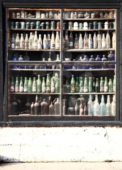 Antique bottles in window of store in Eyebrow, Saskatchewan