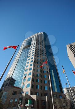 Flag poles in front of new building in downtown Winnipeg