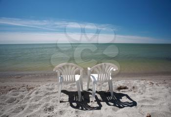 lawn chairs along beach of Lake Winnipeg