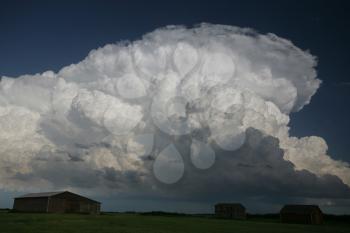 Storm clouds over an old Saskatchewan homestead