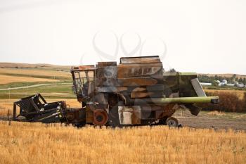 Dismanted rusting combine in a Saskatchewan field