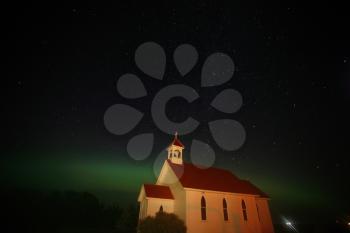Northern Lights and star tracks over Saint Columba church