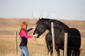 Young girl with horse in scenic Saskatchewan