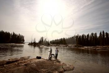 fisherrmen above Pisew Falls in Northern Manitoba