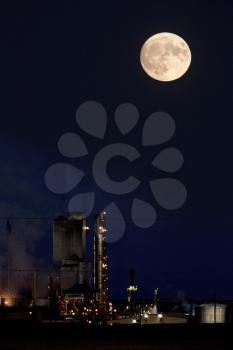 Refinery and super moon in Saskatchewan night