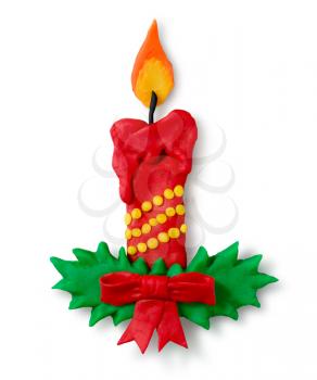 Hand made plasticine figure of Christmas candle with shadow on white background.