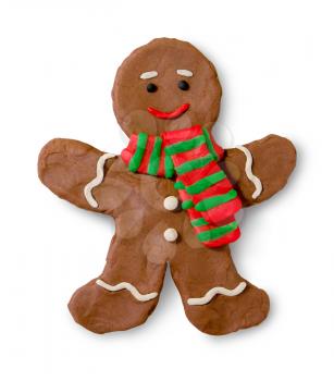 Hand made plasticine figure of gingerbread man cookie with shadow on white background.