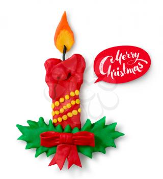 Hand made plasticine figure of Christmas candle with shadow and red lettering banner on white background.