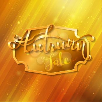 Golden badge in the center and golden words Autumn sale on it. Word Autumn is written from ribbon.