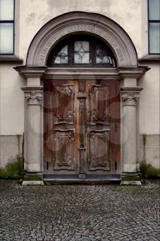 brown door and church in felkierk austria