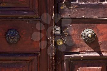 brass brown knocker in a closed wood  door colonia del sacramento uruguay