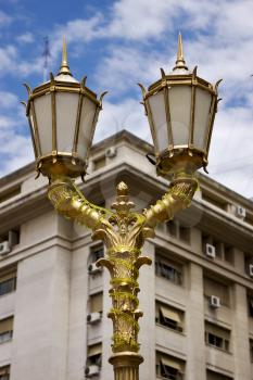  gold street lamp a palace and  cloudy sky  in buenos aires argentina