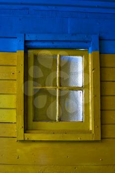 old yellow window in blue wall in the centre of la boca buenos aires argentina 