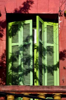 old  yellow little terrace green venetian blind and roof  in the centre of buenos aires la boca argentina