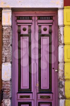 a black violet wood old door in the centre of la boca buenos aires argentina