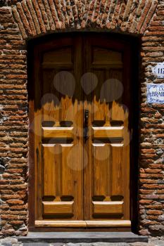 brown wood old door  in the centre of colonia del sacramento uruguay