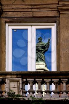a statue of a saint in a window in naples