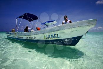 a boat in the blue lagoon of sian kaan in mexico