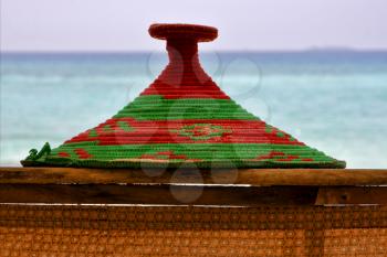 basket wicker rope sand and sea in zanzibar coastline