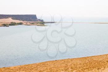 near sandy beach sky and mountain  in oman arabic sea  the hill 