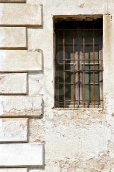 santo antonino window  varese palaces italy   abstract  sunny day    wood venetian blind in the concrete  brick
