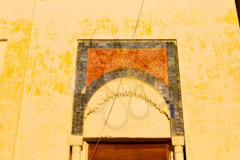 orange   window in morocco africa old construction and brown wall red carpet  