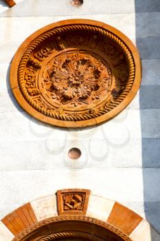  italy  lombardy     in  the mercallo  old   church   closed brick tower   wall rose   window tile   