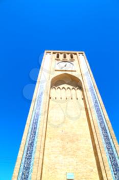 blur in iran old yazd city and the antique brick   clock  tower near the sky