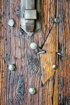 in  italy  patch lombardy    cross castellanza blur   abstract   rusty brass brown knocker  a  door curch  closed wood
