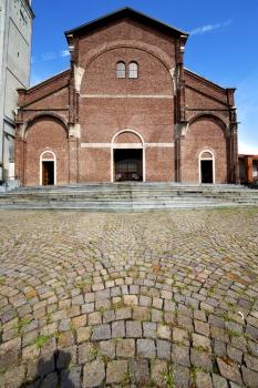 in  the cardano al campo old   church  closed brick tower sidewalk italy  lombardy  