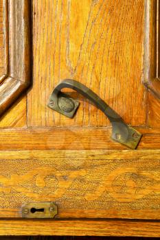  in the travedona monate rusty brass brown knocker a  door curch  closed wood italy  lombardy  