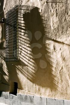 broke abstract old  window grate shadow in italy milan
