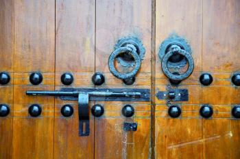 brown  morocco in africa the old wood  facade home and rusty safe padlock 