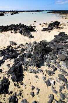 people spain  hill yellow  beach  spiral of black rocks in the   lanzarote 

