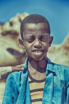ETHIOPIA,BABILE-CIRCA  JANUARY 2018--unidentified   worker young boy in the camels market 
