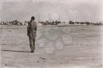  africa  in the land of danakil ethiopia a black soldier and his gun looking the boarder