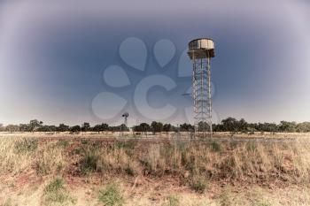 in  australia  the concept of remote in the outback with asphalt line  and water tank