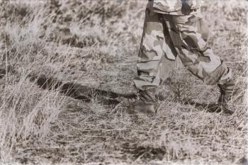 concept in   ethiopia africa  the  bots and legs  of a soldier in the bush walking 