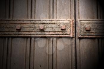 in london antique brown door  rusty  brass nail and light