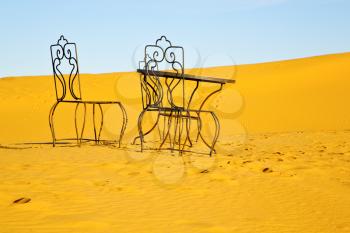 table and seat in  desert sahara morocco   africa yellow sand