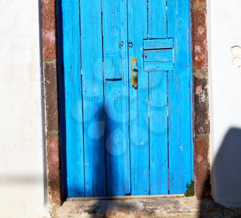 blue door      in antique village santorini greece europe   and white wall